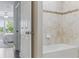 Well-lit bathroom featuring a tub with tiled walls and decorative mosaic trim at 18696 Malinche Loop, Spring Hill, FL 34610