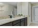 Bathroom featuring a stone countertop, dark cabinets, and neutral wall color at 18696 Malinche Loop, Spring Hill, FL 34610