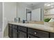 Modern bathroom vanity featuring granite countertops and dark wood cabinets at 18696 Malinche Loop, Spring Hill, FL 34610