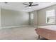 Spacious bedroom with carpet, neutral walls, and a ceiling fan at 18696 Malinche Loop, Spring Hill, FL 34610
