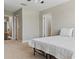 Bedroom featuring neutral carpet, a ceiling fan and white bedding at 18696 Malinche Loop, Spring Hill, FL 34610