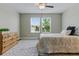 Bright bedroom with a ceiling fan, two windows and carpet featuring a patterned rug at 18696 Malinche Loop, Spring Hill, FL 34610