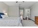 Bedroom featuring hardwood floors, a ceiling fan, and doorway views to other rooms at 18696 Malinche Loop, Spring Hill, FL 34610