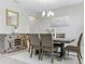 Formal dining room featuring a wooden table, six chairs, modern light fixture and a mirror at 18696 Malinche Loop, Spring Hill, FL 34610