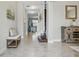 Warm and welcoming foyer with natural light, tiled floor, and staircase at 18696 Malinche Loop, Spring Hill, FL 34610
