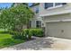 Beautiful home showcasing stone accents, well-maintained landscaping, and a two-car garage at 18696 Malinche Loop, Spring Hill, FL 34610