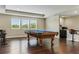 Spacious game room featuring a pool table, hardwood floors, and recessed lighting at 18696 Malinche Loop, Spring Hill, FL 34610