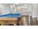 Game room with pool table and hardwood floors leads to a hallway at 18696 Malinche Loop, Spring Hill, FL 34610