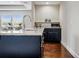 Kitchen island with granite countertops and black cabinetry including a microwave and sink at 18696 Malinche Loop, Spring Hill, FL 34610