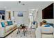 Comfortable living room with a neutral color palette, plush seating, and bright, natural lighting at 18696 Malinche Loop, Spring Hill, FL 34610