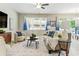 Inviting living room features contemporary furniture, decorative lamps, and a view of the patio at 18696 Malinche Loop, Spring Hill, FL 34610