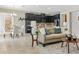 Bright and airy living space featuring a large sofa, modern kitchen, and stylish dining area at 18696 Malinche Loop, Spring Hill, FL 34610