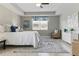 Serene main bedroom with a tray ceiling, plush bedding, and coordinated decor at 18696 Malinche Loop, Spring Hill, FL 34610