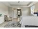 Bright main bedroom features neutral tones, a tray ceiling, a view of the bath, and ample natural light at 18696 Malinche Loop, Spring Hill, FL 34610