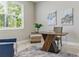 Comfortable home office featuring a unique desk, blue chair, and soothing artwork at 18696 Malinche Loop, Spring Hill, FL 34610