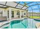 Enjoy a refreshing pool in this screened in lanai with a ceiling fan and well manicured yard at 18696 Malinche Loop, Spring Hill, FL 34610