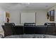 Cozy theater room with a projector screen and comfortable leather seating arrangement at 18696 Malinche Loop, Spring Hill, FL 34610