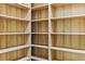Bright, walk-in closet features built-in wooden shelving at 18696 Malinche Loop, Spring Hill, FL 34610