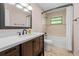 Bathroom showcasing tiled shower, bathtub and vanity with modern sink at 19555 Phillips Rd, Brooksville, FL 34604