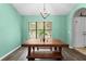 Inviting dining room with modern chandelier, large window, and a wooden dining table set at 19555 Phillips Rd, Brooksville, FL 34604