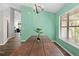 This dining room has a large window and a mint accent wall at 19555 Phillips Rd, Brooksville, FL 34604