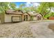 Lovely exterior featuring mature trees, an extended driveway, and charming facade at 19555 Phillips Rd, Brooksville, FL 34604