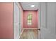 Hallway with hardwood flooring, a window, and access to a room at 19555 Phillips Rd, Brooksville, FL 34604
