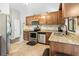 Kitchen featuring stainless steel appliances, tile backsplash, granite countertops, and light-colored tile flooring at 19555 Phillips Rd, Brooksville, FL 34604