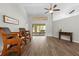 Open living room features a view of screened in porch, new laminate flooring and vaulted ceilings at 19555 Phillips Rd, Brooksville, FL 34604