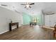 Bright living room features new laminate flooring, a ceiling fan, and plenty of natural light at 19555 Phillips Rd, Brooksville, FL 34604