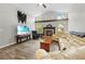 Well-lit living room with fireplace, large sectional sofa, and a TV for entertainment at 19555 Phillips Rd, Brooksville, FL 34604