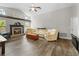 Bright living room featuring a brick fireplace, vaulted ceilings, and a large, comfortable sofa at 19555 Phillips Rd, Brooksville, FL 34604