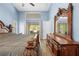 Main bedroom with a view of the screened-in porch and a luxurious wooden dresser set at 19555 Phillips Rd, Brooksville, FL 34604