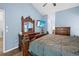 Main bedroom featuring a large bed, dresser, and a TV, offering a relaxing retreat at 19555 Phillips Rd, Brooksville, FL 34604
