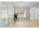 Well-lit office space featuring tile flooring, a window view, and access to the screened-in porch at 19555 Phillips Rd, Brooksville, FL 34604