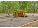 Wooden pig pen providing shelter for multiple pigs on a wooded property at 19555 Phillips Rd, Brooksville, FL 34604