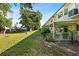 Large backyard featuring a covered patio and mature trees, perfect for outdoor enjoyment at 2192 Swedish Dr # 10, Clearwater, FL 33763