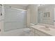 Bathroom with shower, sliding glass doors, vanity, sink, and white toilet at 2192 Swedish Dr # 10, Clearwater, FL 33763
