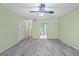 Spacious bedroom featuring hardwood floors, a ceiling fan, and ensuite access at 2192 Swedish Dr # 10, Clearwater, FL 33763