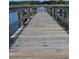 Wooden dock leading out onto the water, offering access and scenic views of the serene lake at 2192 Swedish Dr # 10, Clearwater, FL 33763