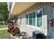 Condo exterior featuring well-maintained landscaping, brick facade, and shaded entryway at 2192 Swedish Dr # 10, Clearwater, FL 33763