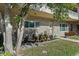 Brick condo unit featuring a welcoming garden, rocking chairs, and a pleasant, landscaped walkway at 2192 Swedish Dr # 10, Clearwater, FL 33763