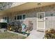 Brick condo unit featuring a welcoming garden, rocking chairs, and a pleasant, landscaped walkway at 2192 Swedish Dr # 10, Clearwater, FL 33763