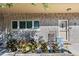 Charming brick condo exterior featuring rocking chairs, colorful plants, and a welcoming front door at 2192 Swedish Dr # 10, Clearwater, FL 33763