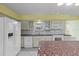 Bright kitchen featuring white appliances, countertops, and updated cabinetry at 2192 Swedish Dr # 10, Clearwater, FL 33763