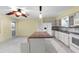 Updated kitchen with a center island, white cabinetry, and modern fixtures at 2192 Swedish Dr # 10, Clearwater, FL 33763