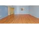 Open living room with hardwood floors and chandelier at 2192 Swedish Dr # 10, Clearwater, FL 33763