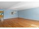 Large living room featuring hardwood floors, blue accent wall, and modern chandelier at 2192 Swedish Dr # 10, Clearwater, FL 33763
