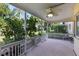 Relaxing covered patio featuring a ceiling fan and view of greenery in a quiet backyard setting at 2192 Swedish Dr # 10, Clearwater, FL 33763