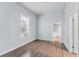Cozy bedroom with wood-look floors, neutral walls, and lots of natural light at 2320 W Walnut St, Tampa, FL 33607